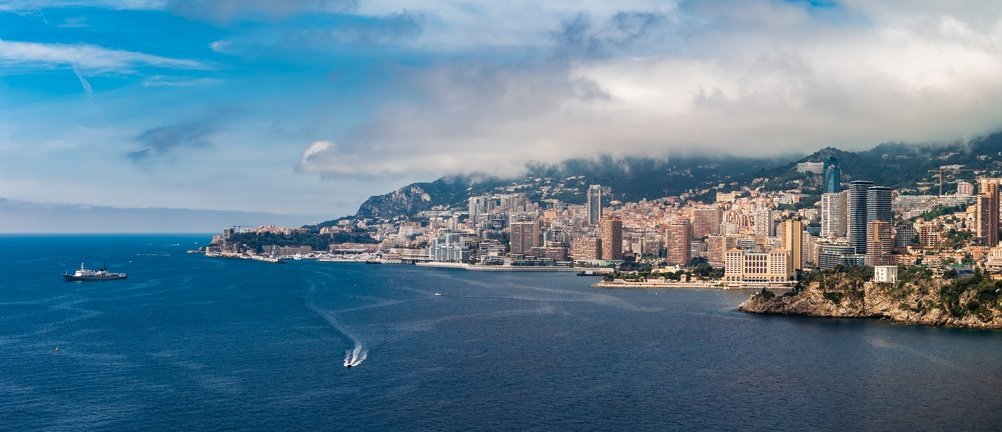 Aerial photo of Monaco showing Monte Carlo, Port Hercule and Larvotto Beach
