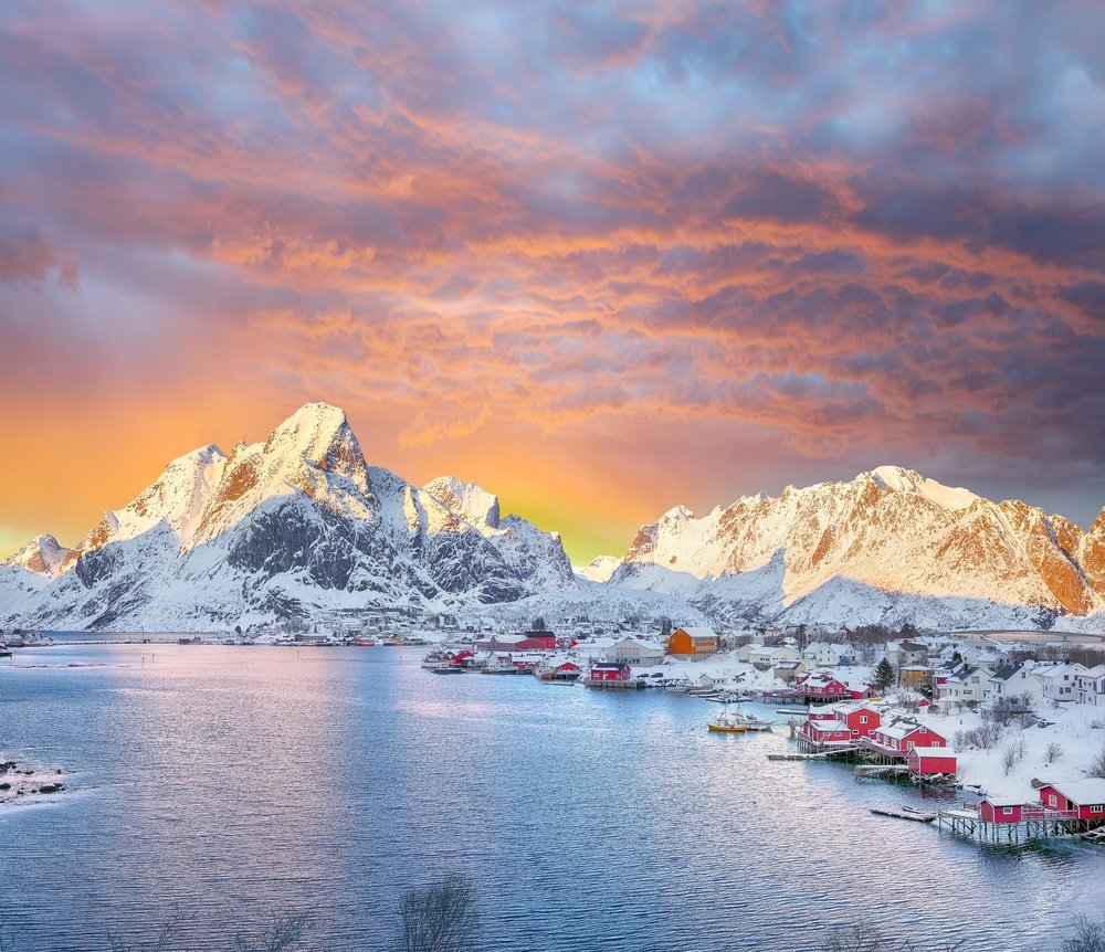 Where to stay in Norway: Reine in the Lofoten Islands, with red rorbuer cabins beneath the mountains