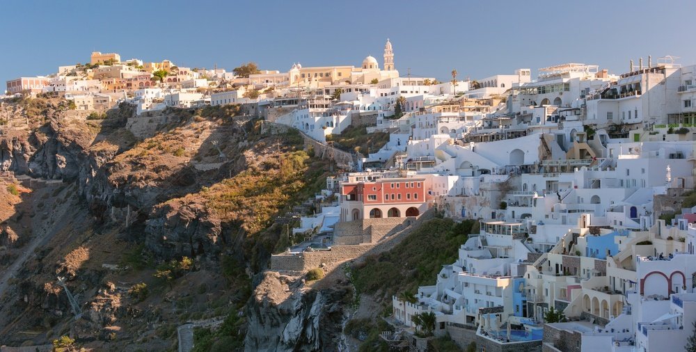 white buildings and churches on the cliff in Fira